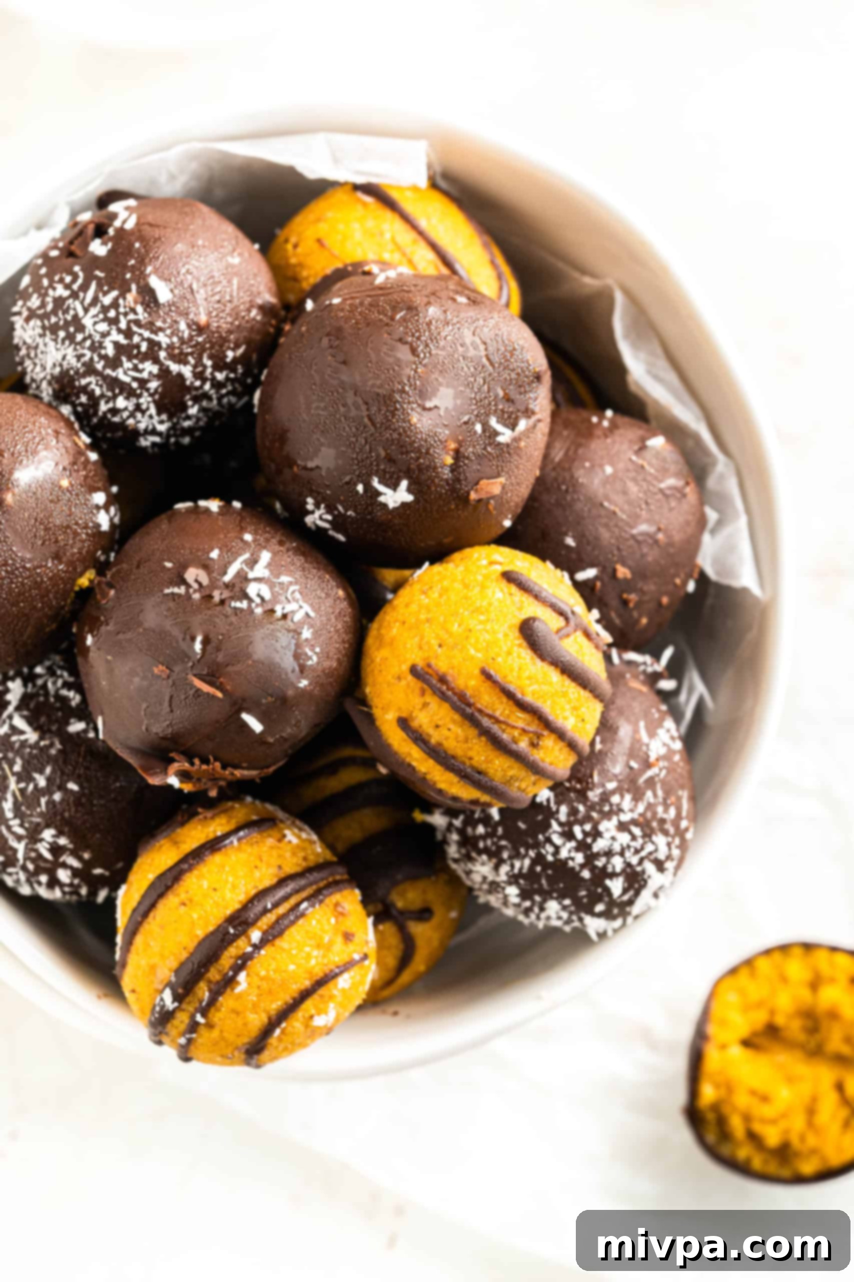 No-Bake Chocolate Pumpkin Truffles (Gluten-Free, Vegan) A bowl of gluten-free pumpkin truffles, coated in rich chocolate and ready to be enjoyed as a healthy fall treat.