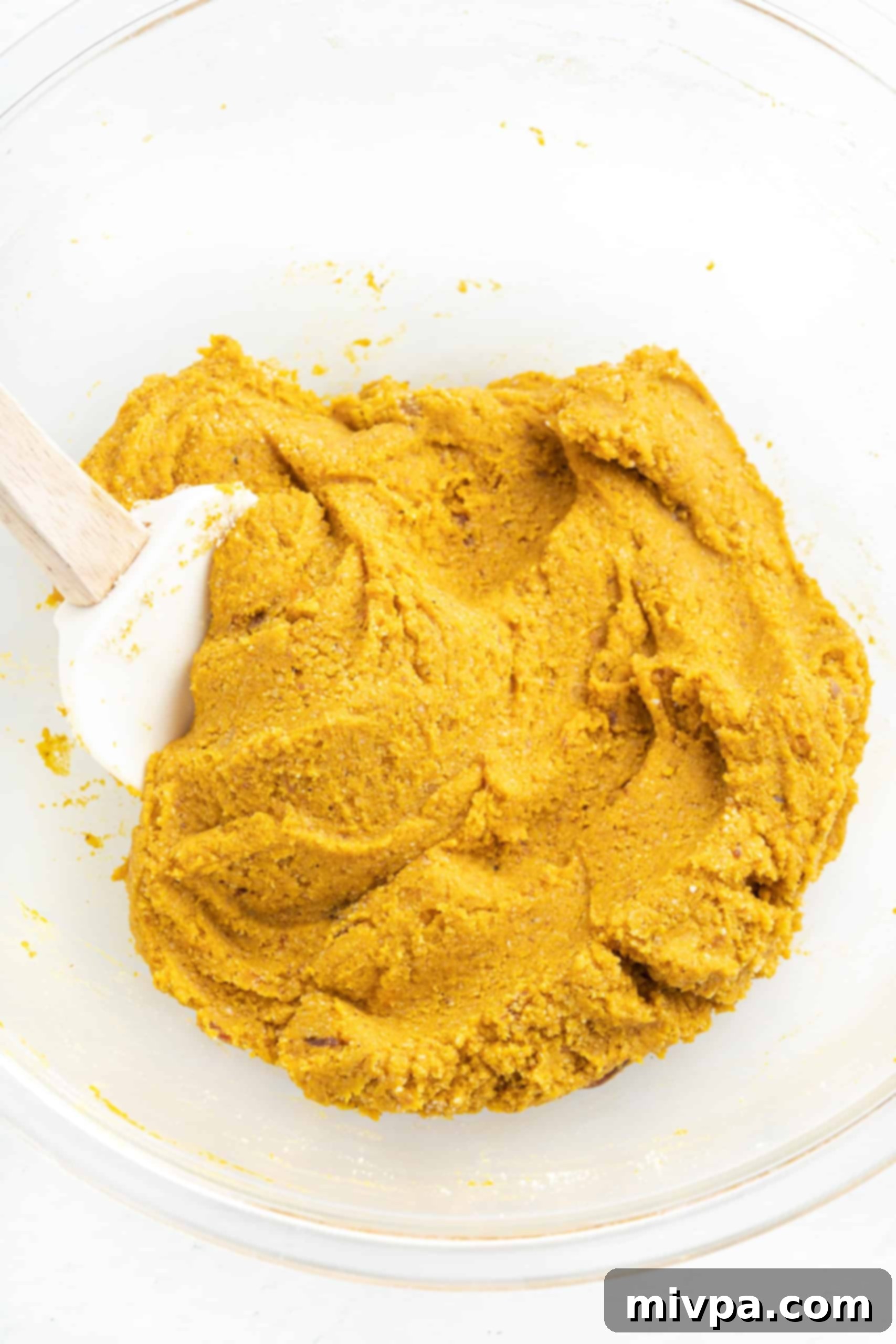 Vegan Pumpkin Truffles (Gluten-Free, Vegan) A glass bowl showcasing the perfectly formed pumpkin truffle dough, dense and ready for shaping.