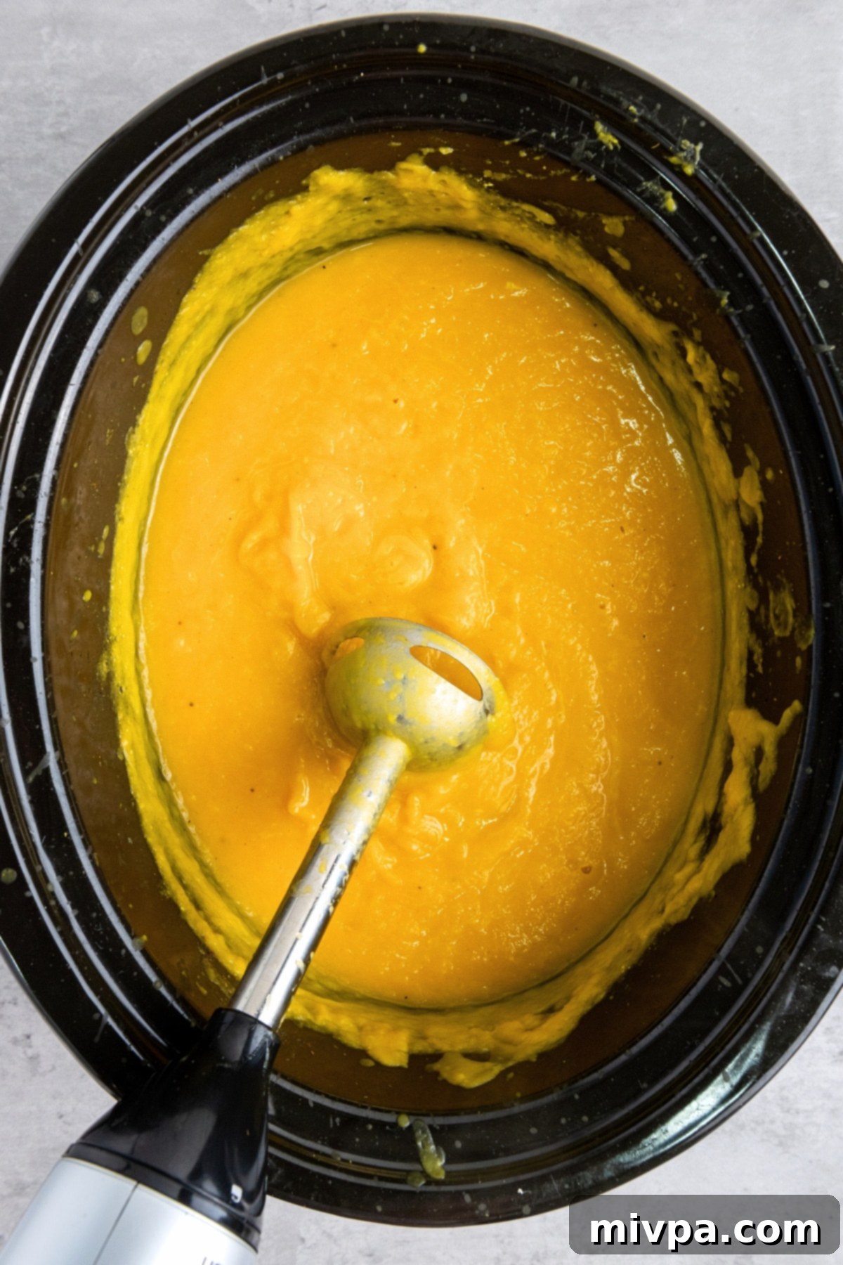 Gluten-Free Vegan Butternut Squash Soup Processing butternut squash soup in slow cooker.