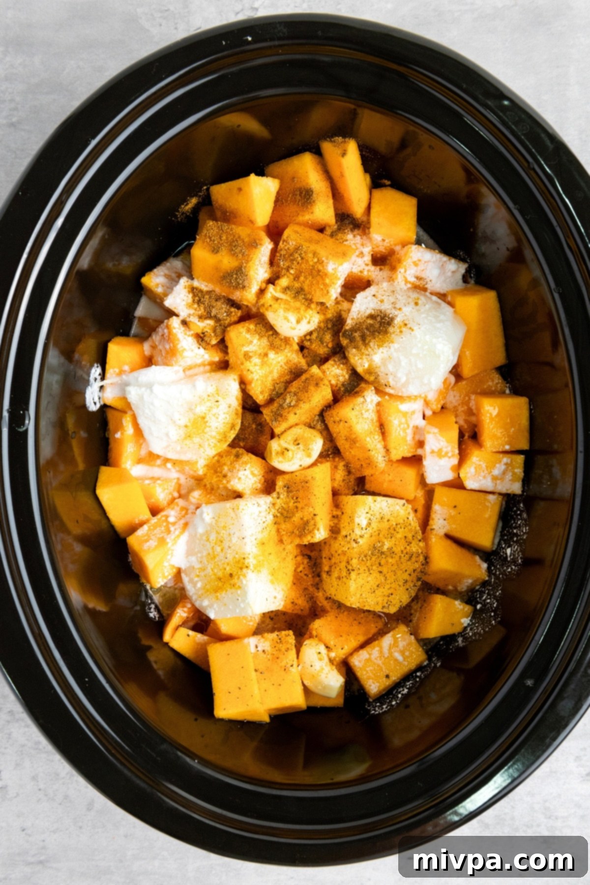 Savory Butternut Squash Soup Recipe (Gluten-Free, Vegan) Cubed butternut squash, onions and garlic and spices in slow cooker.