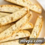 A close-up of delicious gluten-free almond biscotti, showcasing its perfect texture and golden-brown hue.