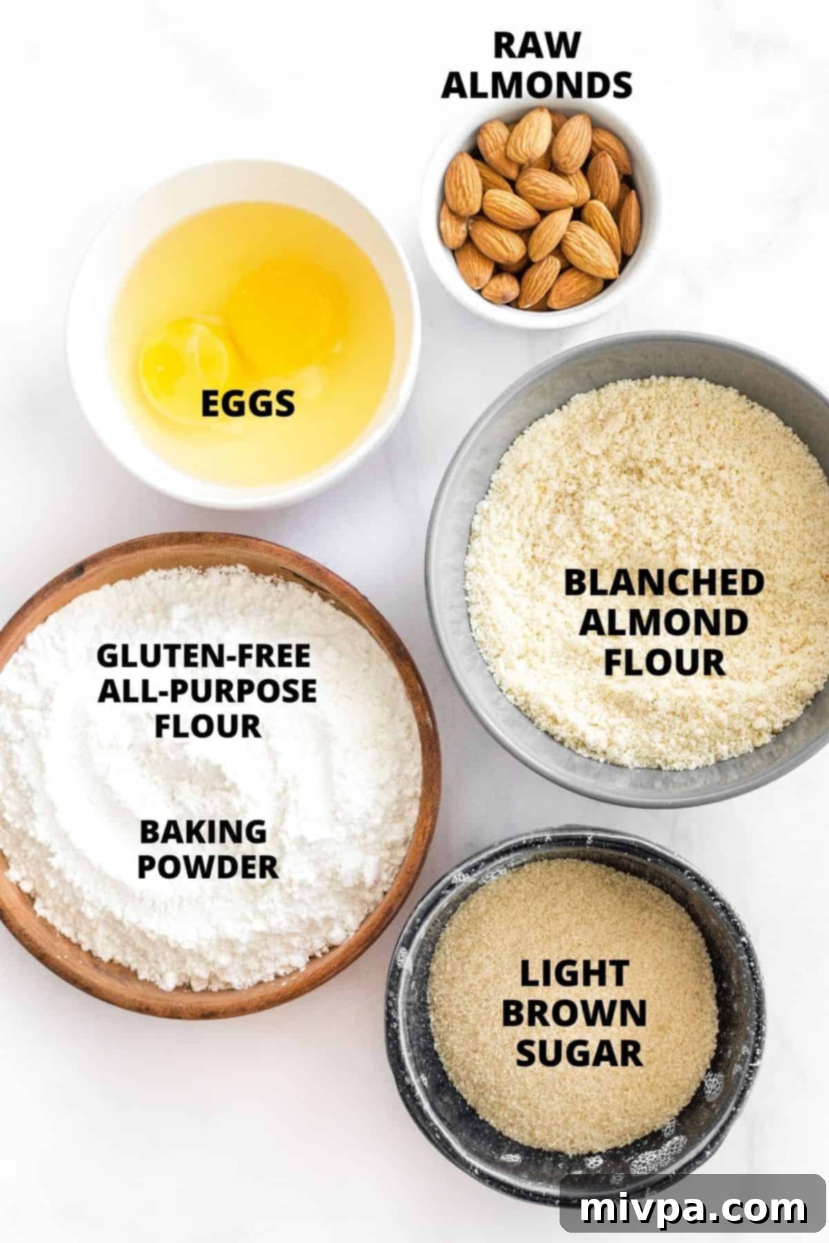 A clear, organized display of all the labeled ingredients required to bake gluten-free almond biscotti, from flours to almonds.