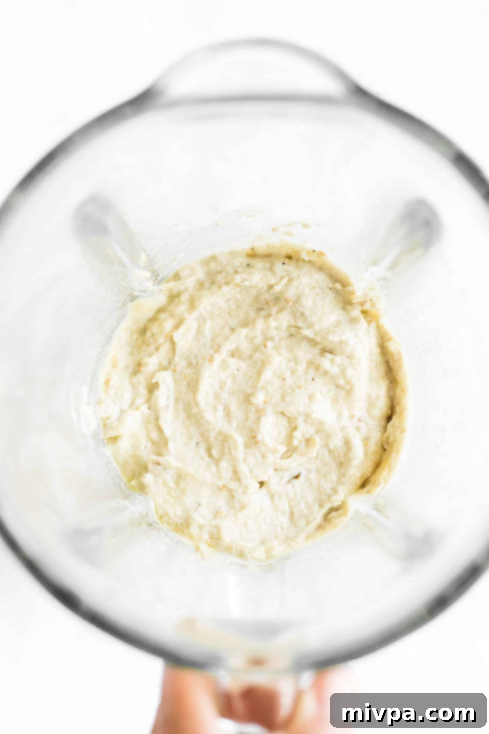 Processed dip in the bowl of a blender.