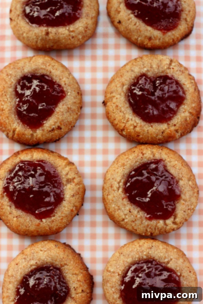 Berry-Kissed Grain-Free Thumbprints 6 Grain-free strawberry thumbprint cookies on a vintage plate