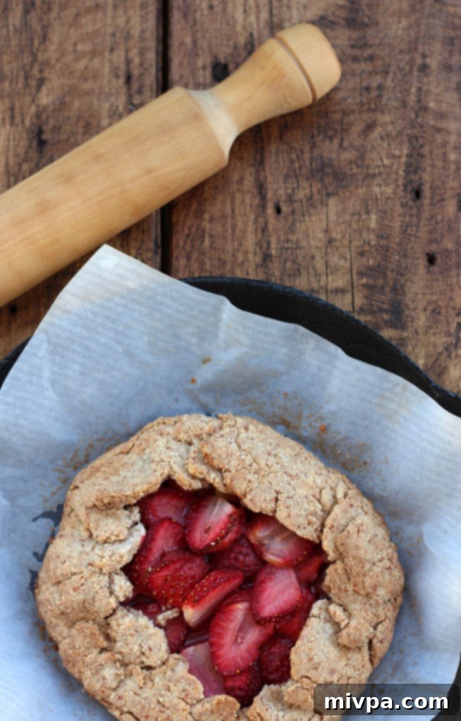 Rustic Grain-free Strawberry Almond Galette on a wooden surface
