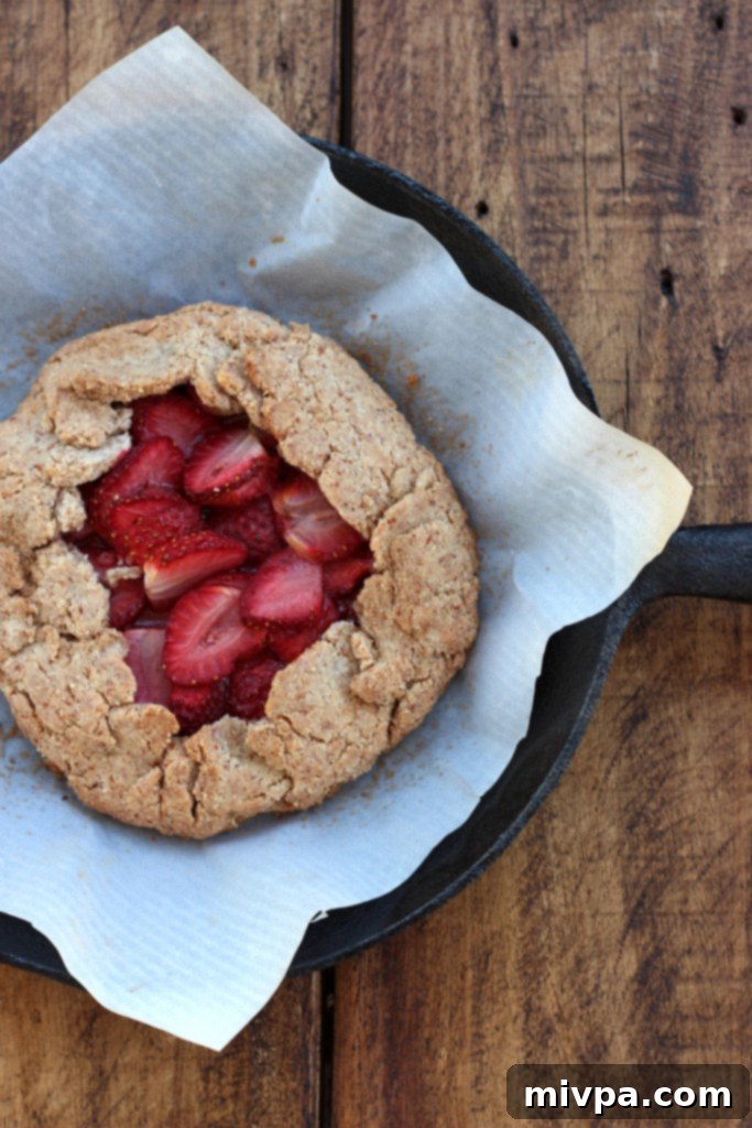 A close-up of a partially baked Grain-free Strawberry Almond Galette