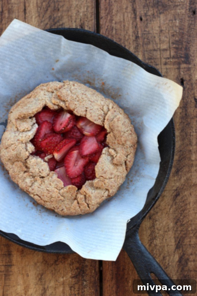 A slice of Grain-free Strawberry Almond Galette with berries