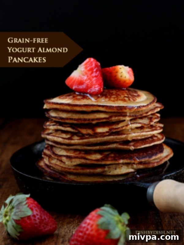 Grain-free Yogurt Almond Pancakes topped with fresh strawberries
