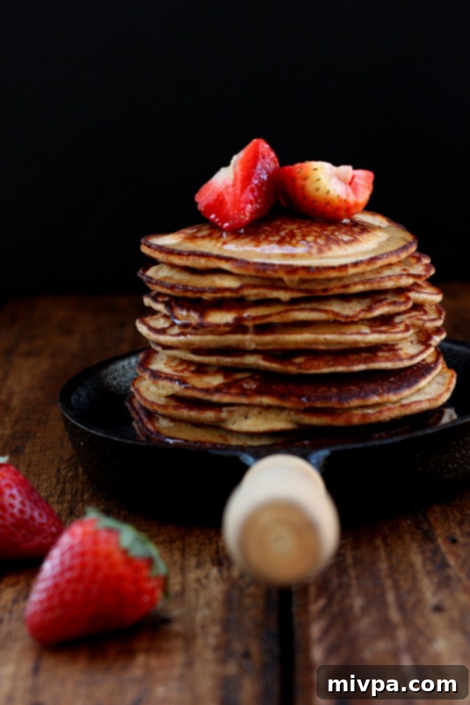 Fresh strawberries piled on top of pancakes