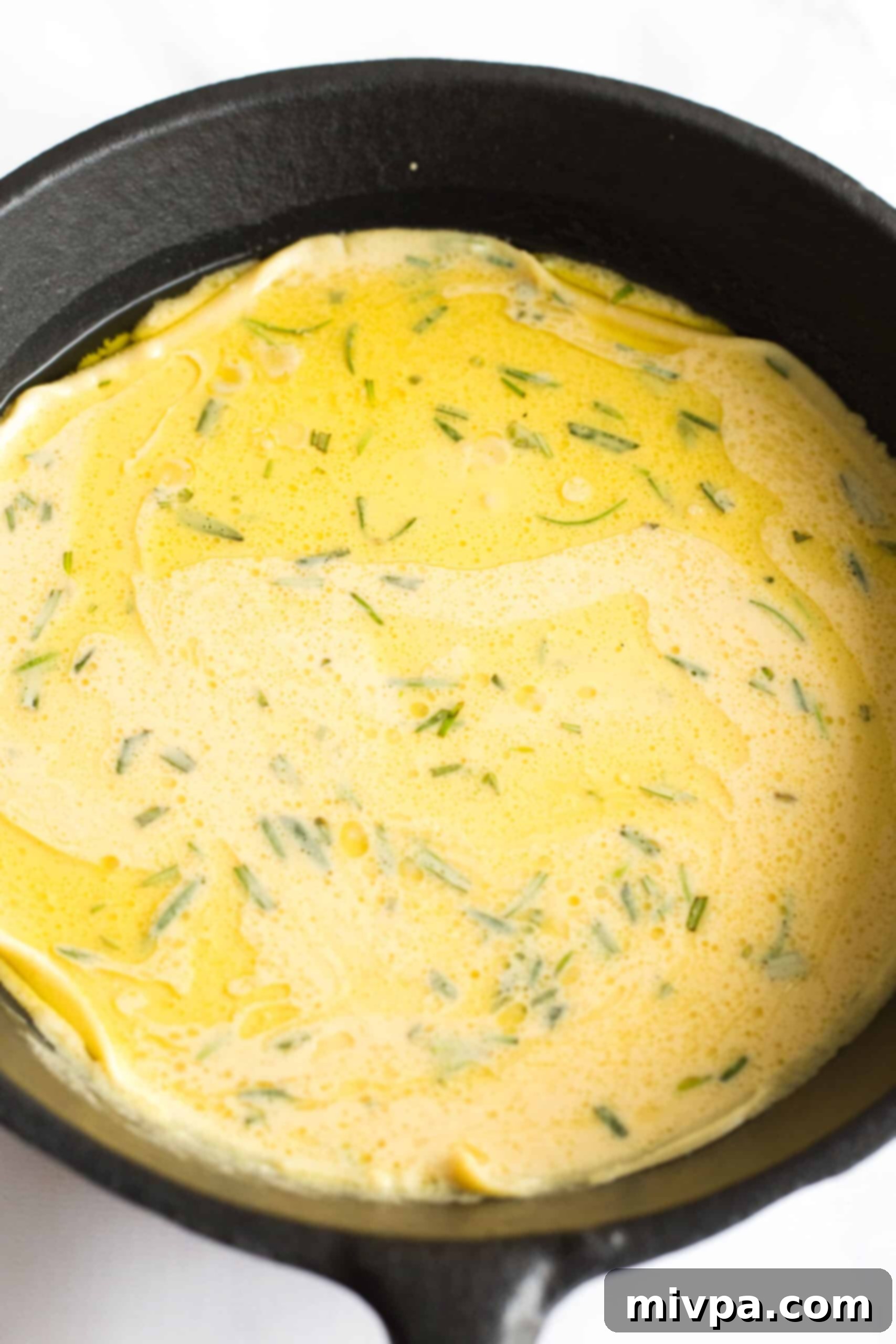 Easy Farinata Recipe - Chickpea Flatbread (Gluten-Free, Vegan) Chickpea batter poured into a hot cast iron skillet, ready for baking.