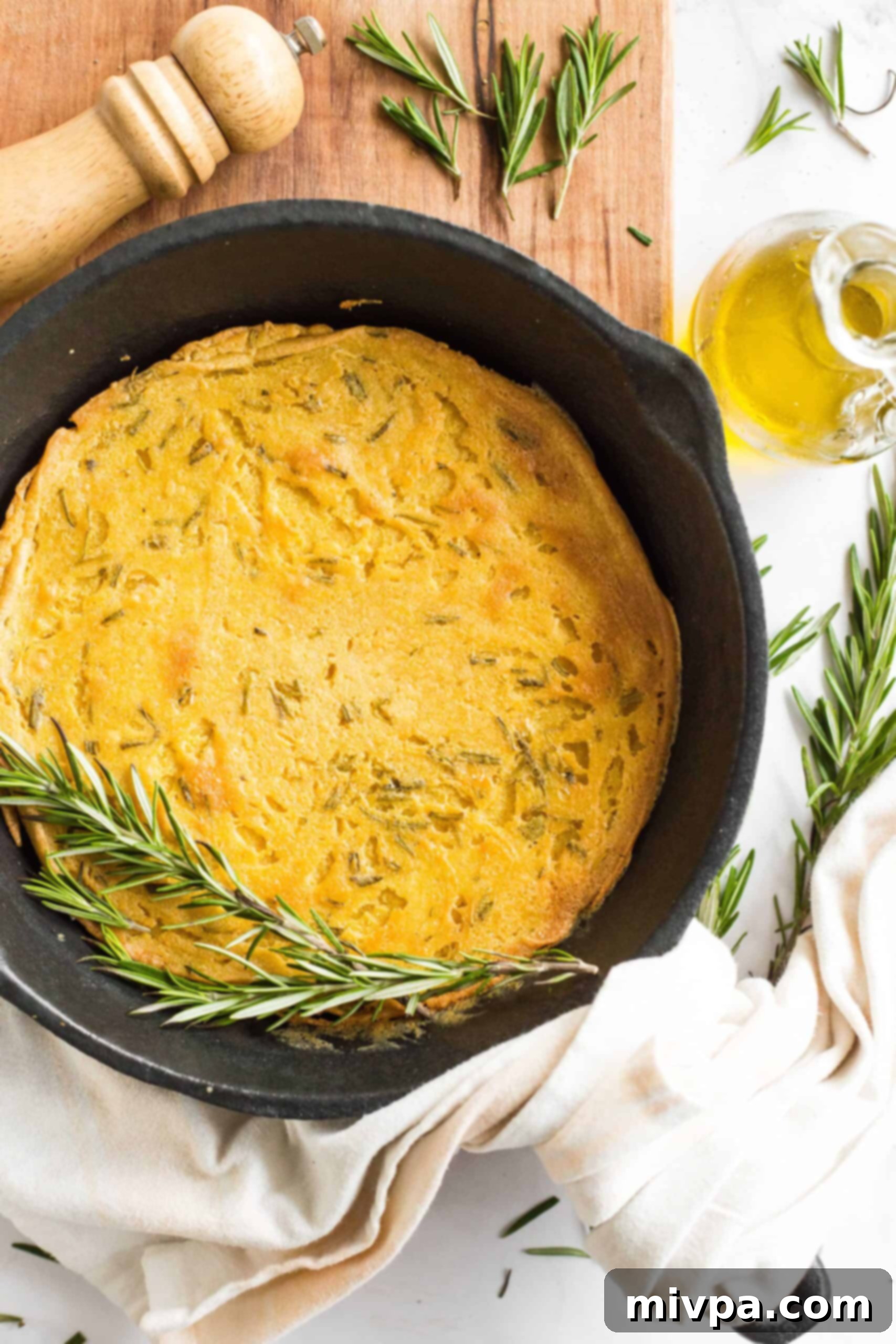 Easy Farinata Recipe - Chickpea Flatbread (Gluten-Free, Vegan) A freshly baked, golden-brown farinata, still in the cast iron pan, showing a perfectly crispy surface.