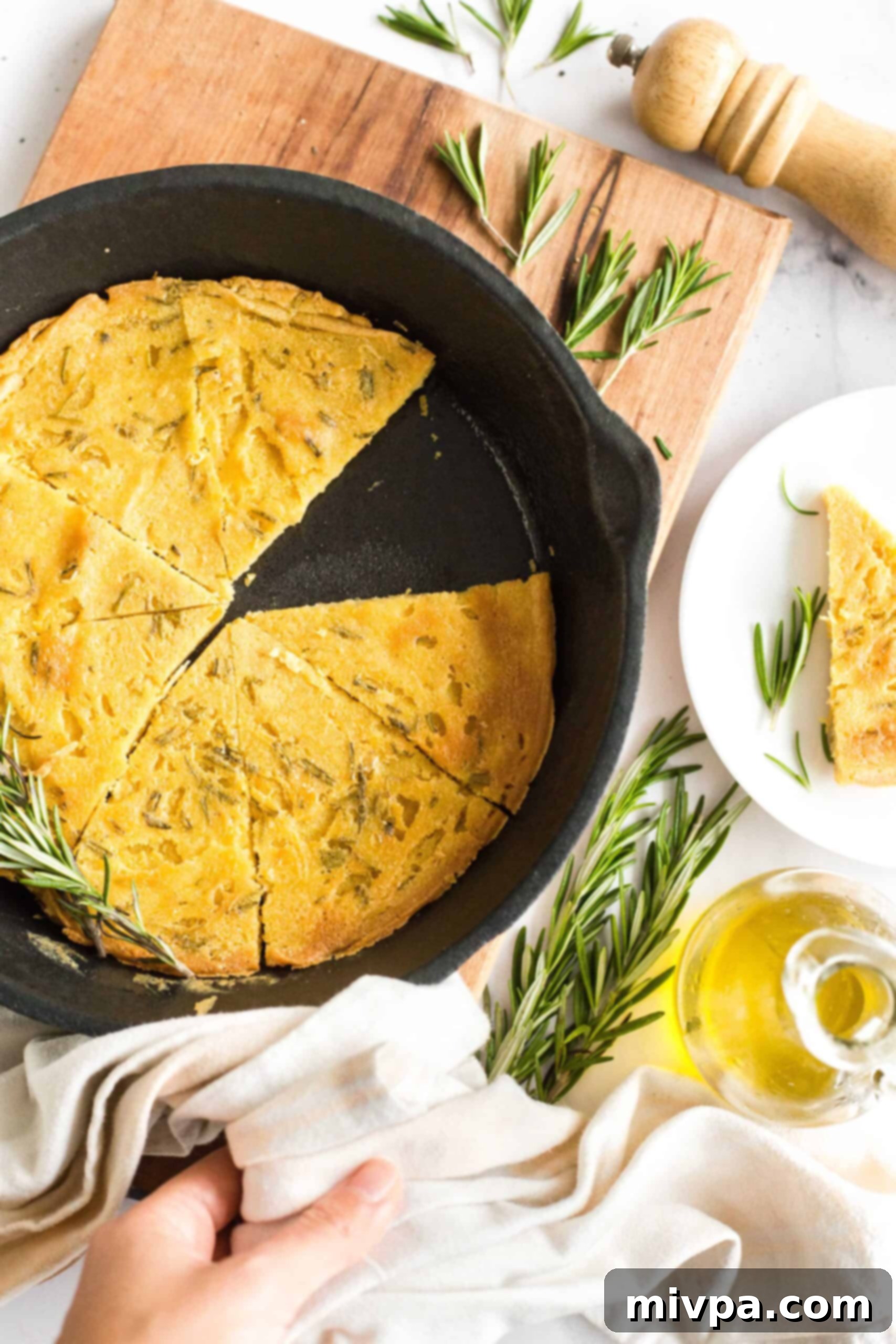 Easy Farinata Recipe - Chickpea Flatbread (Gluten-Free, Vegan) A half-eaten farinata in a cast iron skillet, with several wedges already removed, inviting more.