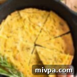 Easy Chickpea Farinata Flatbread Gluten Free Vegan 2 Reaching for a slice of farinata from cast iron skillet