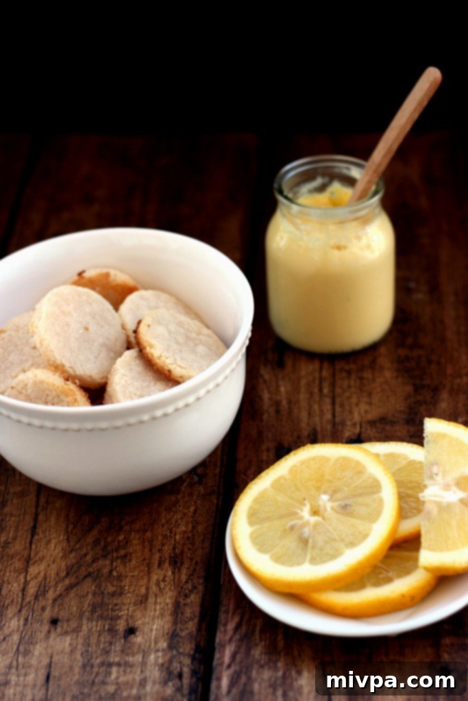Grain-free Lemon Sandwich Cookies – A close-up shot of a single cookie, highlighting its golden-brown edges and the rich lemon curd.
