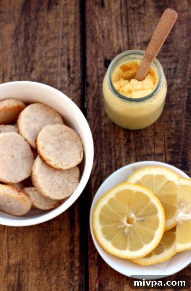 Grain-free Lemon Sandwich Cookies – A top-down view of several cookies arranged artfully on a light background, emphasizing their round shape.