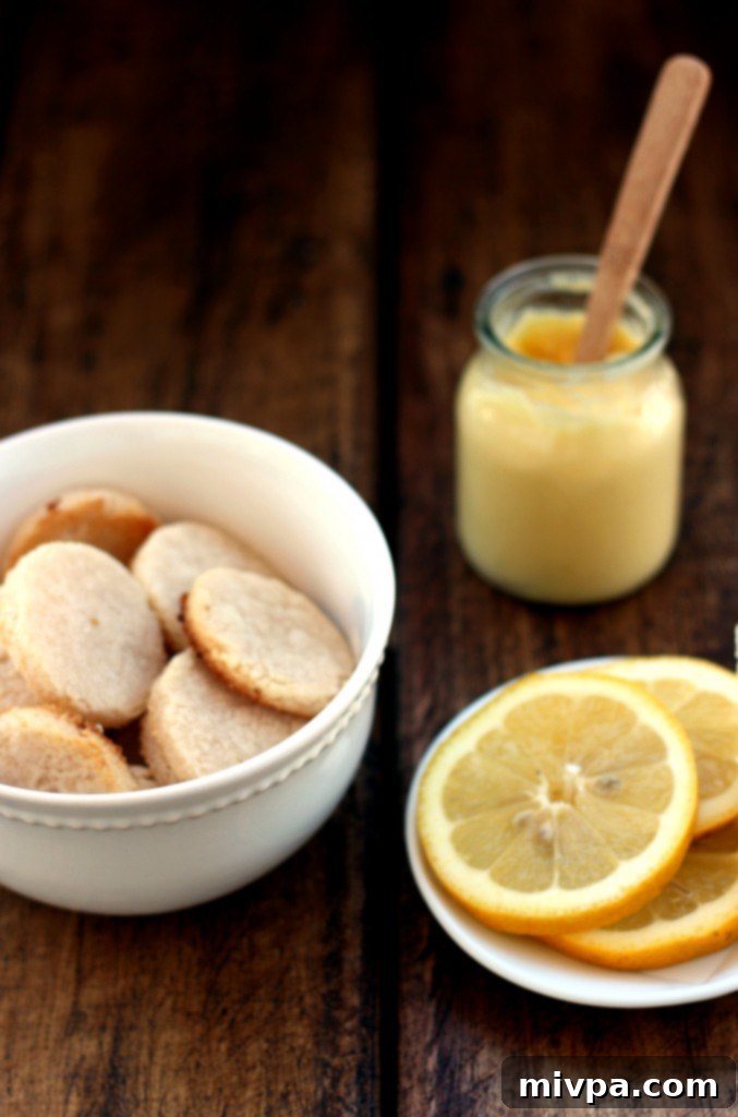 Grain-free Lemon Sandwich Cookies – Freshly cut cookie shapes laid out on a baking sheet, ready for the oven.