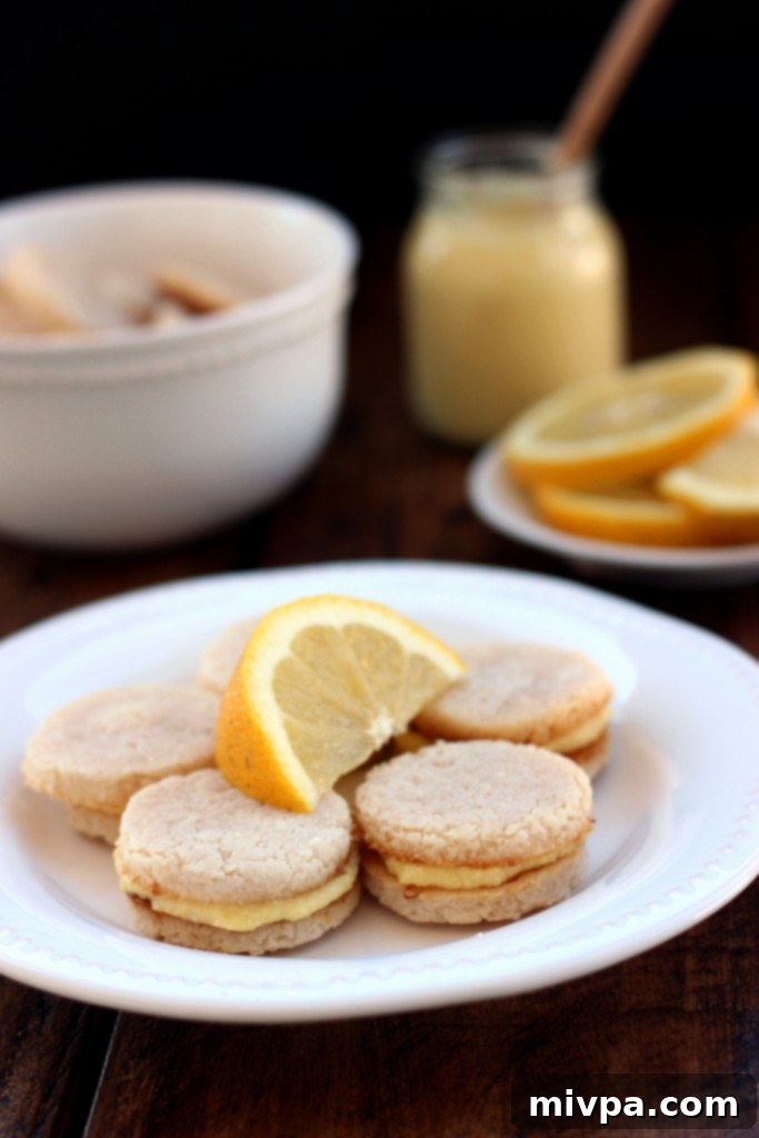 Grain-free Lemon Sandwich Cookies – A stack of finished cookies, some with filling, on a plate ready to be enjoyed.