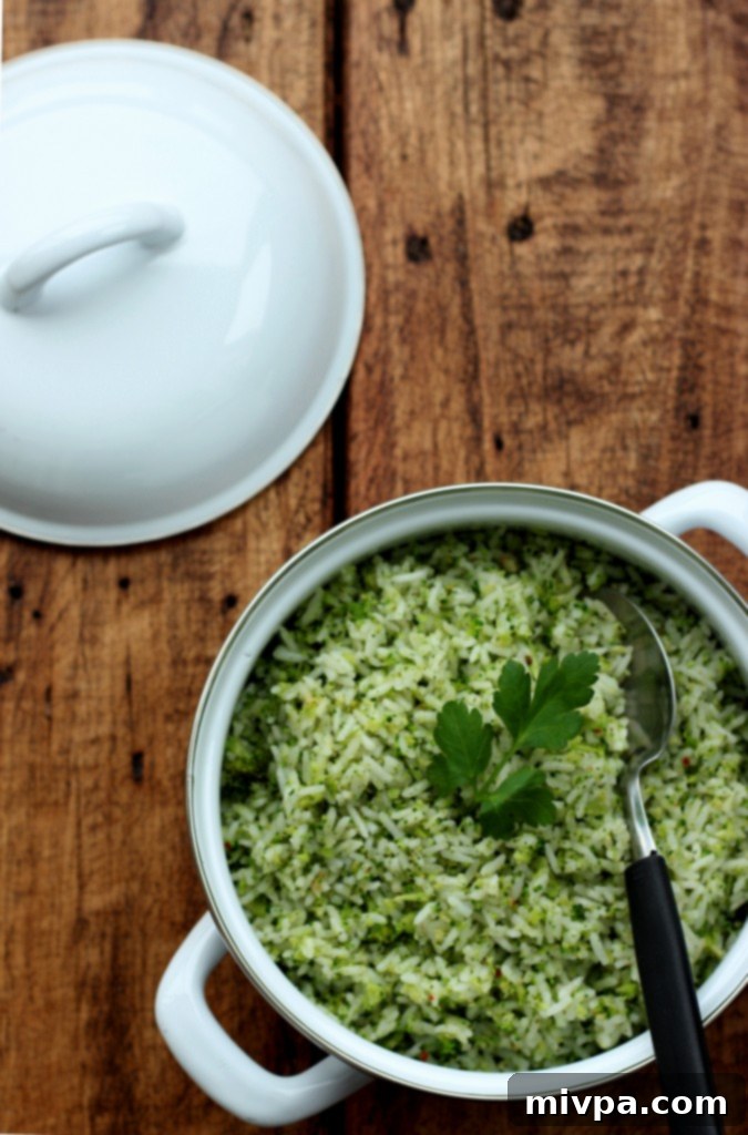 A close-up view of sautéed garlic and finely chopped broccoli florets in a pan, cooking together