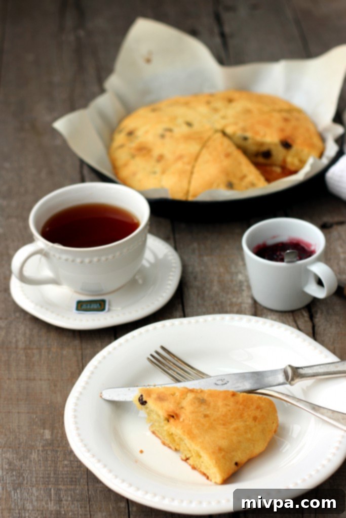A slice of Gluten-free Raisin Scone on a small plate