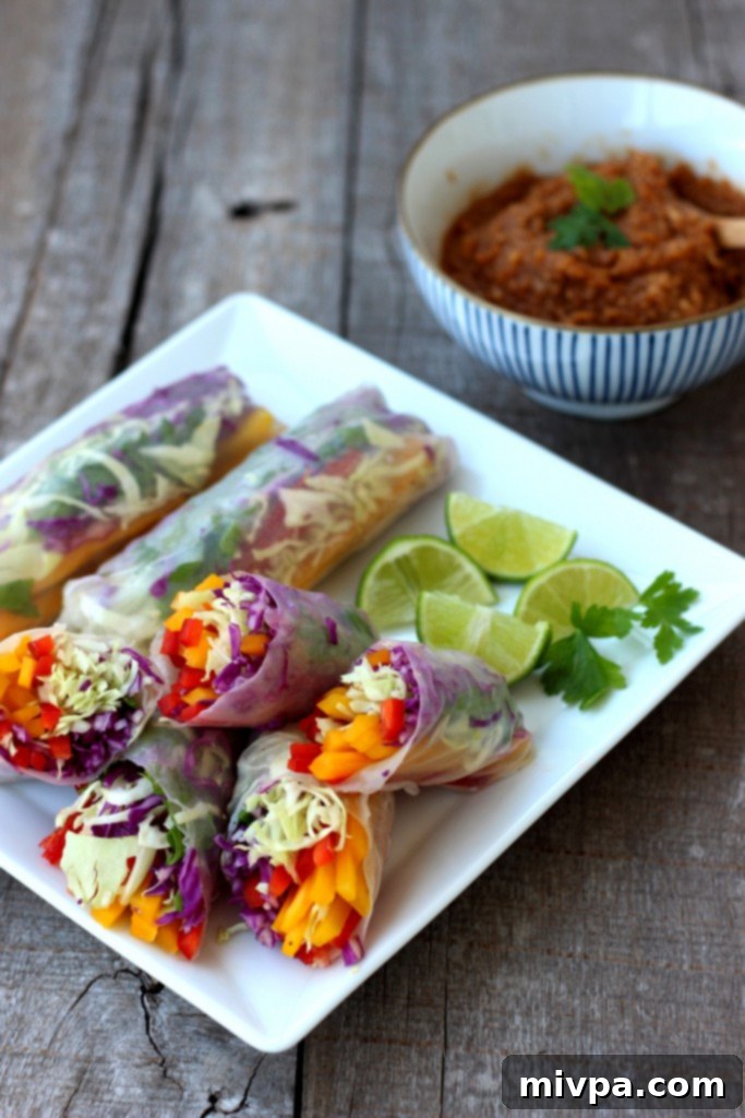 Close-up of Rainbow Vegetable Rolls ready to be dipped in Spicy Peanut Sauce
