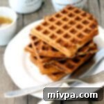 Up close shot of a stack of oat flour waffles, golden and inviting.