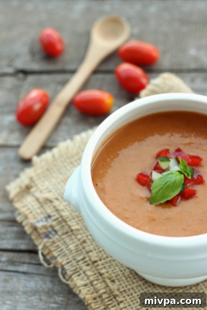 Vibrant Tomato & Bell Pepper Gazpacho, a refreshing cold Spanish soup.