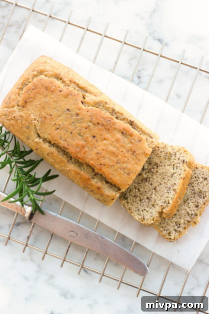 Hand holding a slice of Grain-free Rosemary Almond Bread