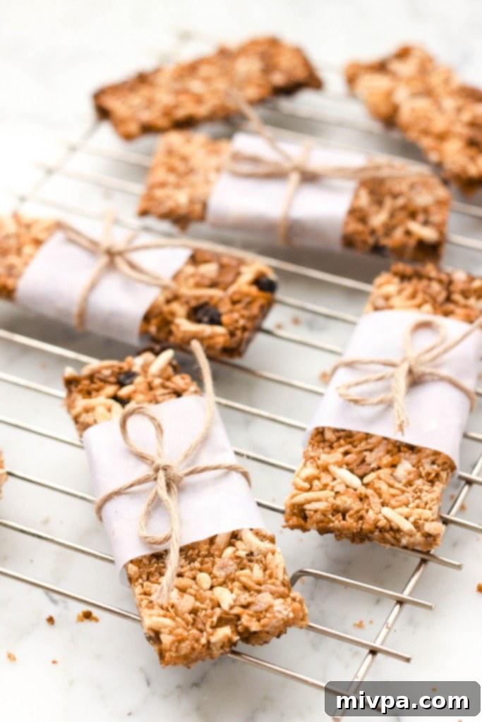 Freshly baked gluten-free granola bars cooling on a wire rack, showing their golden color and various ingredients.