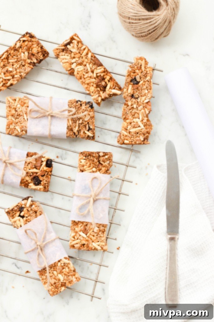 Crunchy Gluten-free Granola Bars on a wire rack with a patterned kitchen towel on the right, highlighting their homemade appeal.