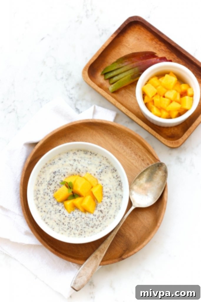 Mango Chia Pudding (Gluten-Free, Vegan) Top down view of mango chia pudding in a bowl, with a spoon ready to scoop.