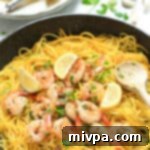 Buttery Garlic Shrimp with Sun-Kissed Squash Ribbons 6 Garlic Butter Shrimp with Yellow Squash Noodles cooked in a pan