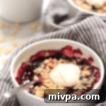 Gluten Free Vegan Berry Crisp 3 Gluten-free Mixed Berry Crisp served in a ramekin with a dairy-free ice cream scoop.