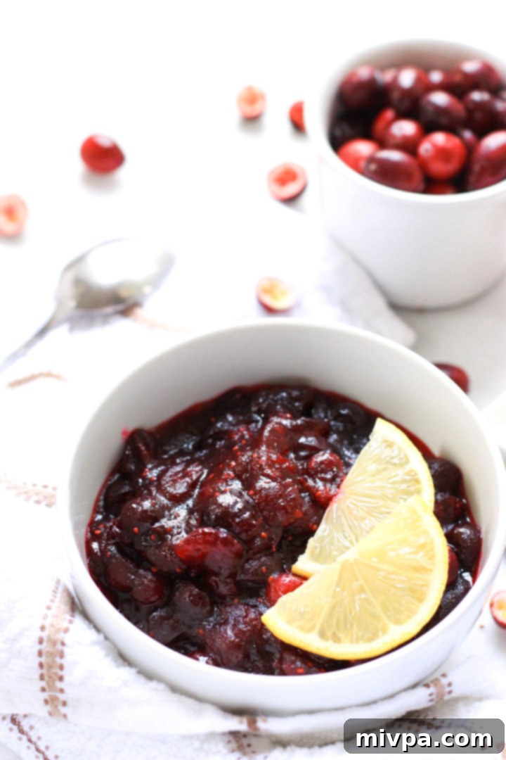 20-Minute Gluten-Free Cranberry Sauce (Dairy-Free, Vegan) Up close shot of gluten-free cranberry sauce in a white bowl.