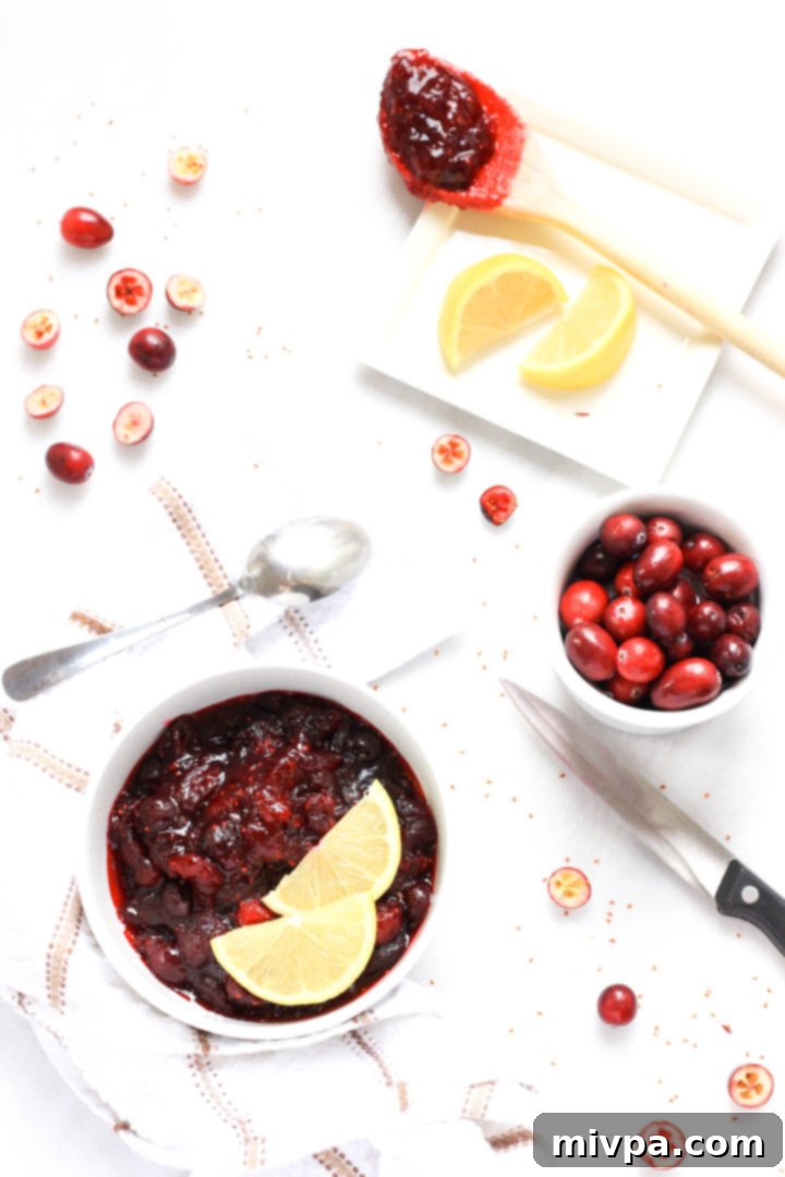 20-Minute Homemade Cranberry Sauce (Gluten-Free, Vegan) Top-down view of homemade cranberry sauce and ingredients for the sauce on the table.