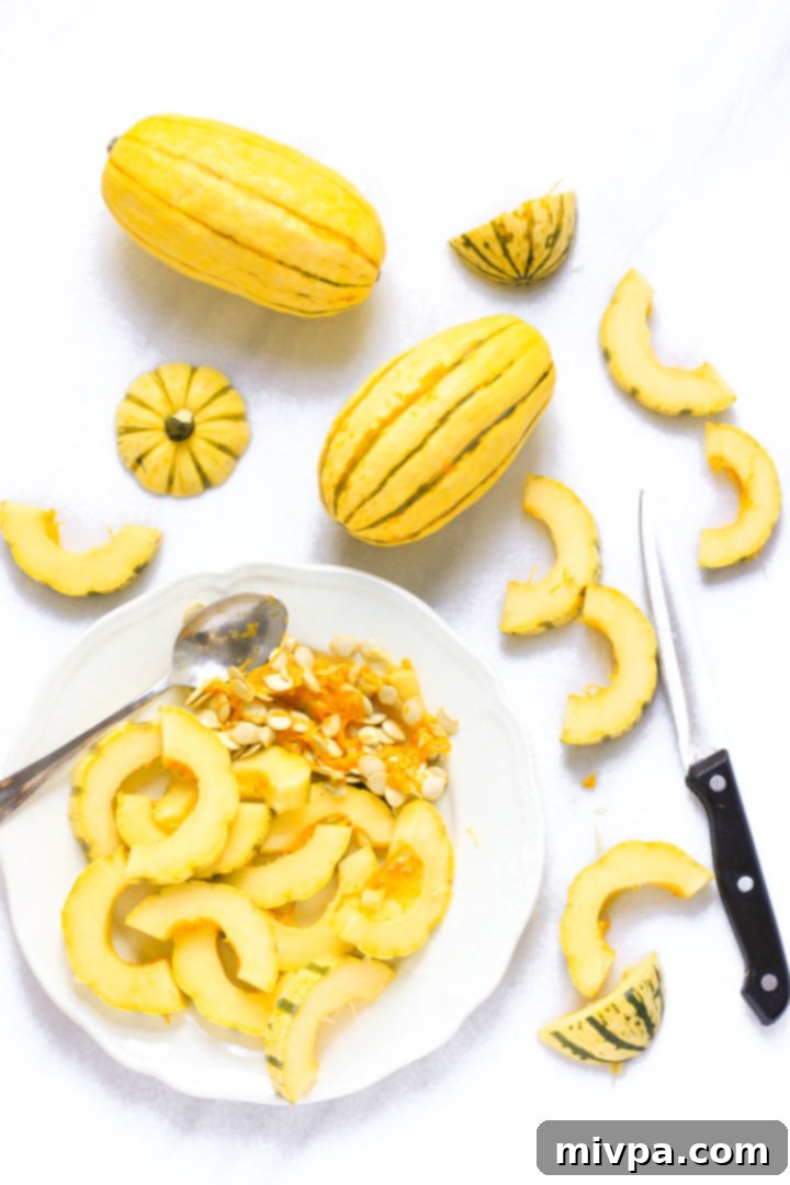 Roasted Delicata Squash Salad Recipe (Gluten-Free, Vegan) Sliced delicata squash and seeds on a plate.