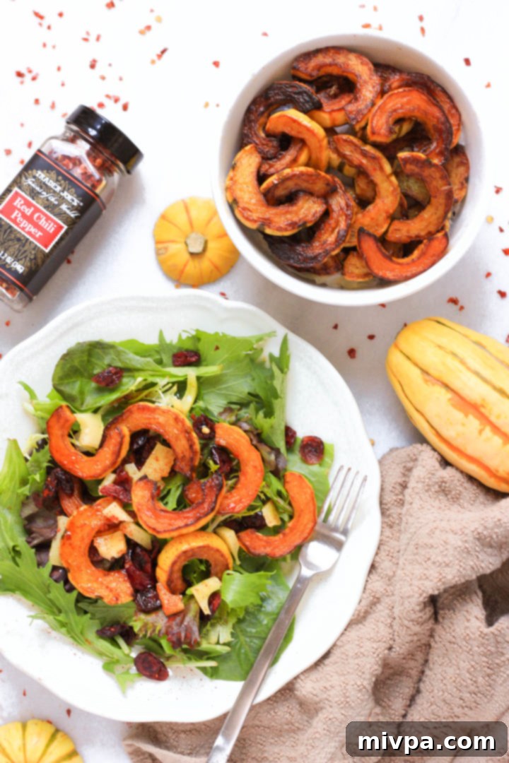 Roasted Delicata Squash Salad Recipe (Gluten-Free, Vegan) Top down view of roasted delicata squash and fresh greens on plate.