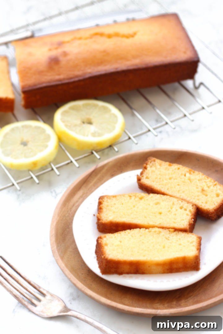 Sliced gluten-free lemon cake on a plate.