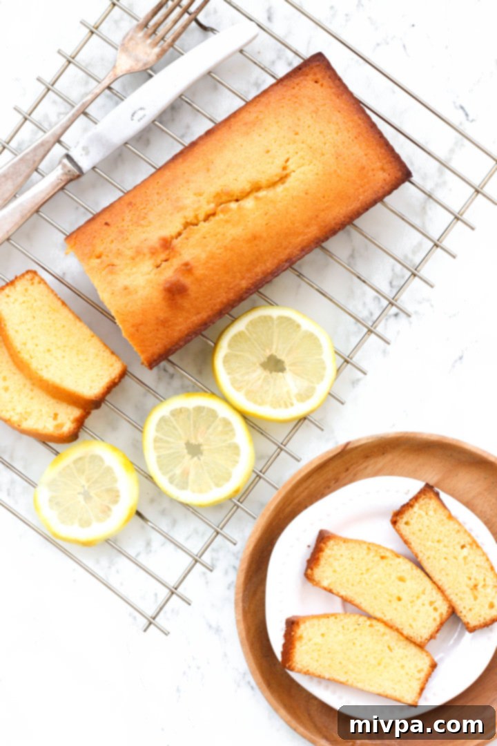 Top down shot of a sliced gluten-free lemon pound cake on a cooling rack.