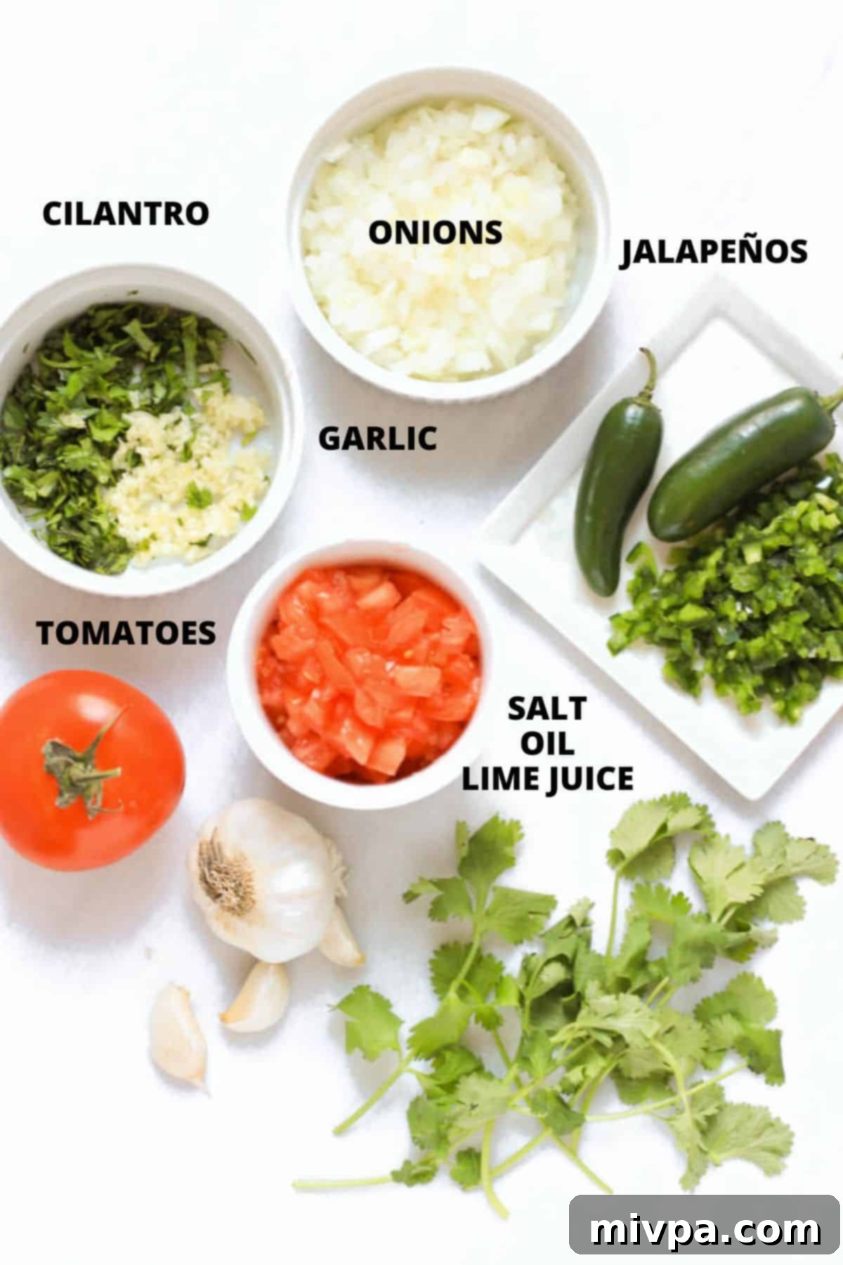 Ingredients for pico de gallo recipe laid out on marble board.