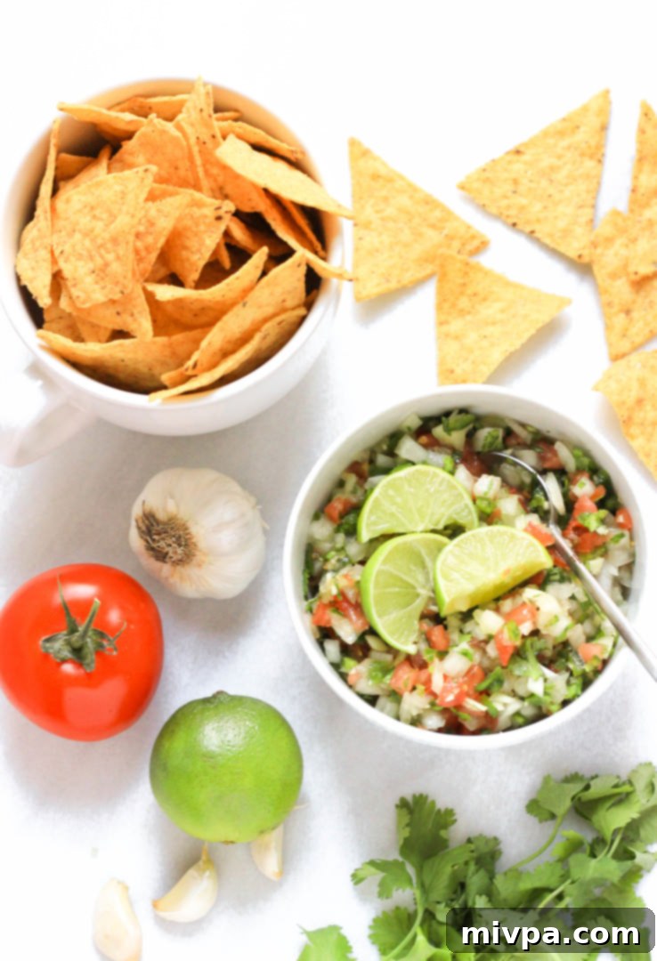Top down view of a bowl of salsa fresca and tortilla chips