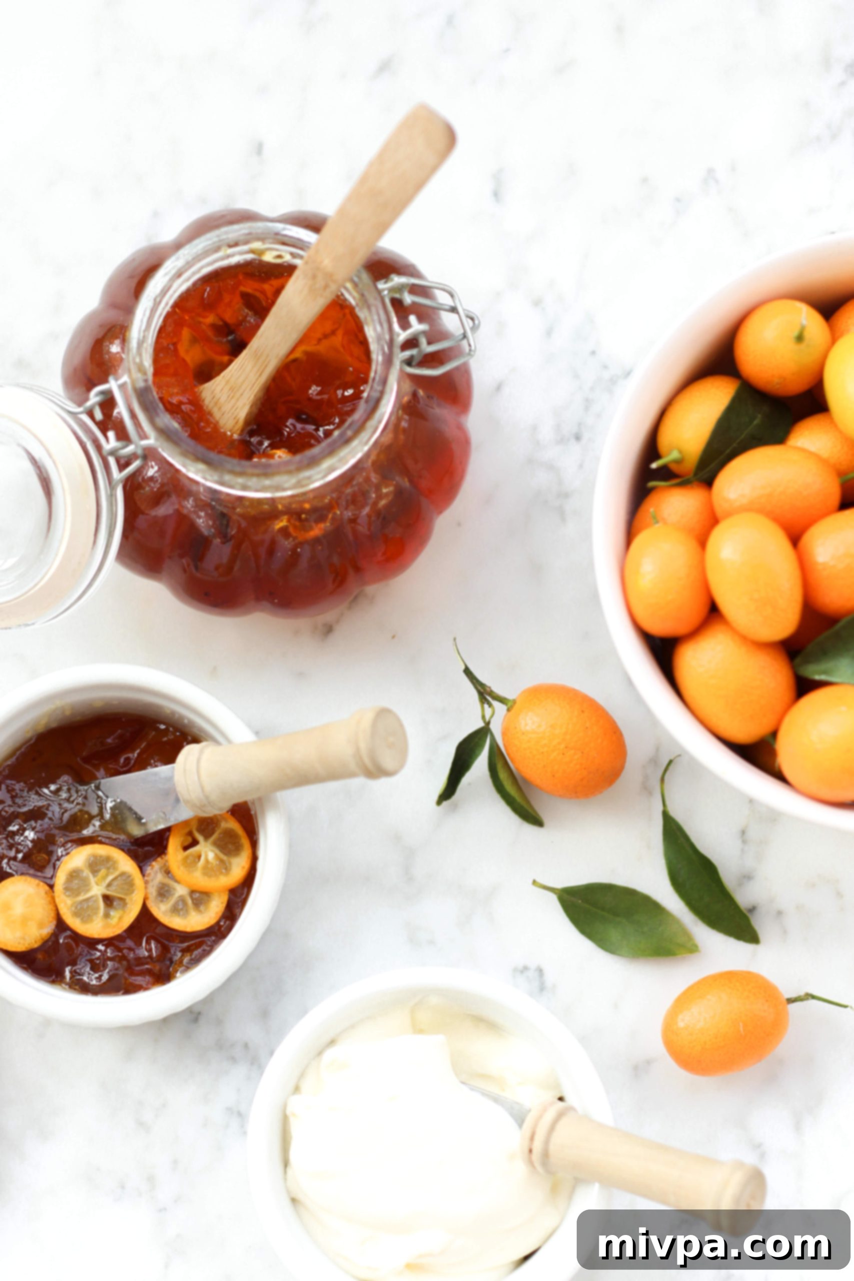 Easy Kumquat Marmalade Recipe (Gluten-Free, Vegan, Pectin-Free) Top down view of kumquat marmalade and fresh kumquats on marble. A close-up shot of the finished marmalade in a jar, highlighting its texture and color, surrounded by fresh kumquats.