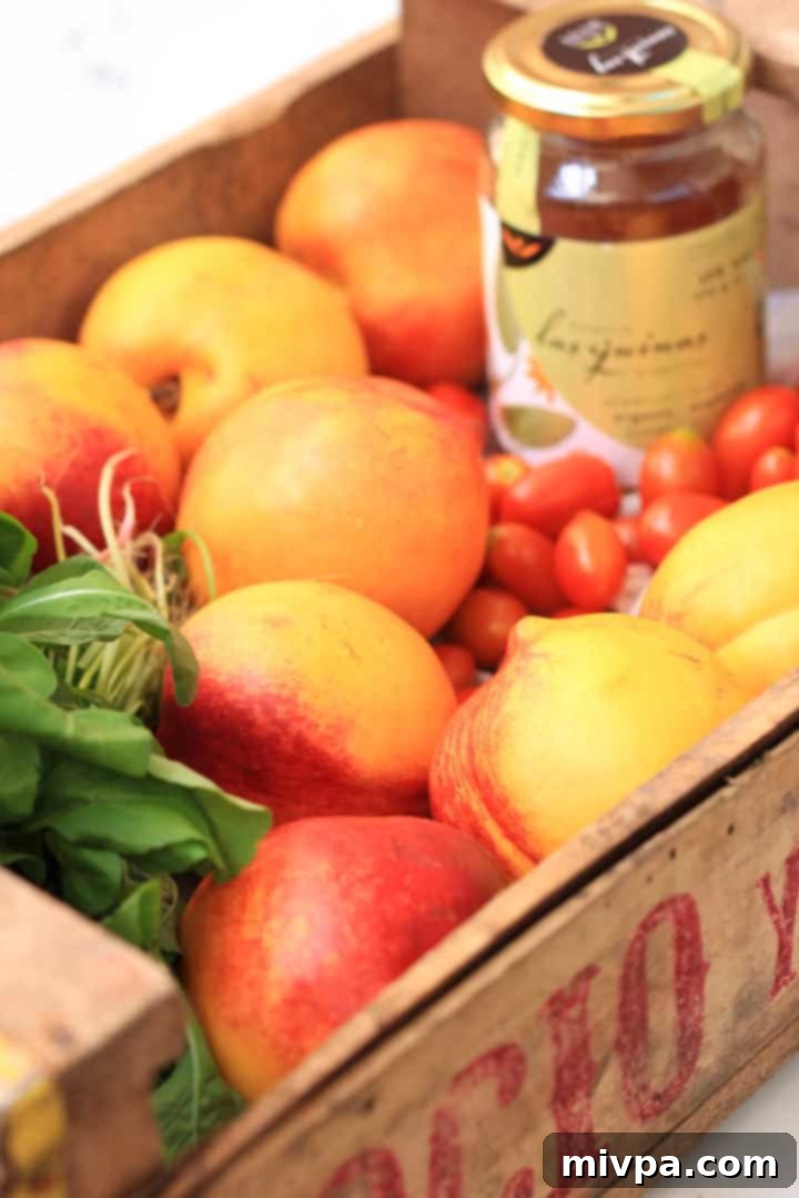 The vibrant Peach, Arugula & Tomato Salad with Honey Olive Oil Dressing, ready to be served.