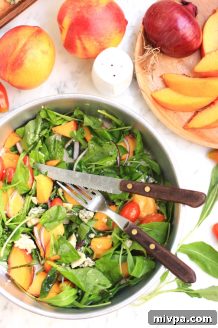 Another perspective of the Peach, Arugula & Tomato Salad, highlighting the colorful combination.