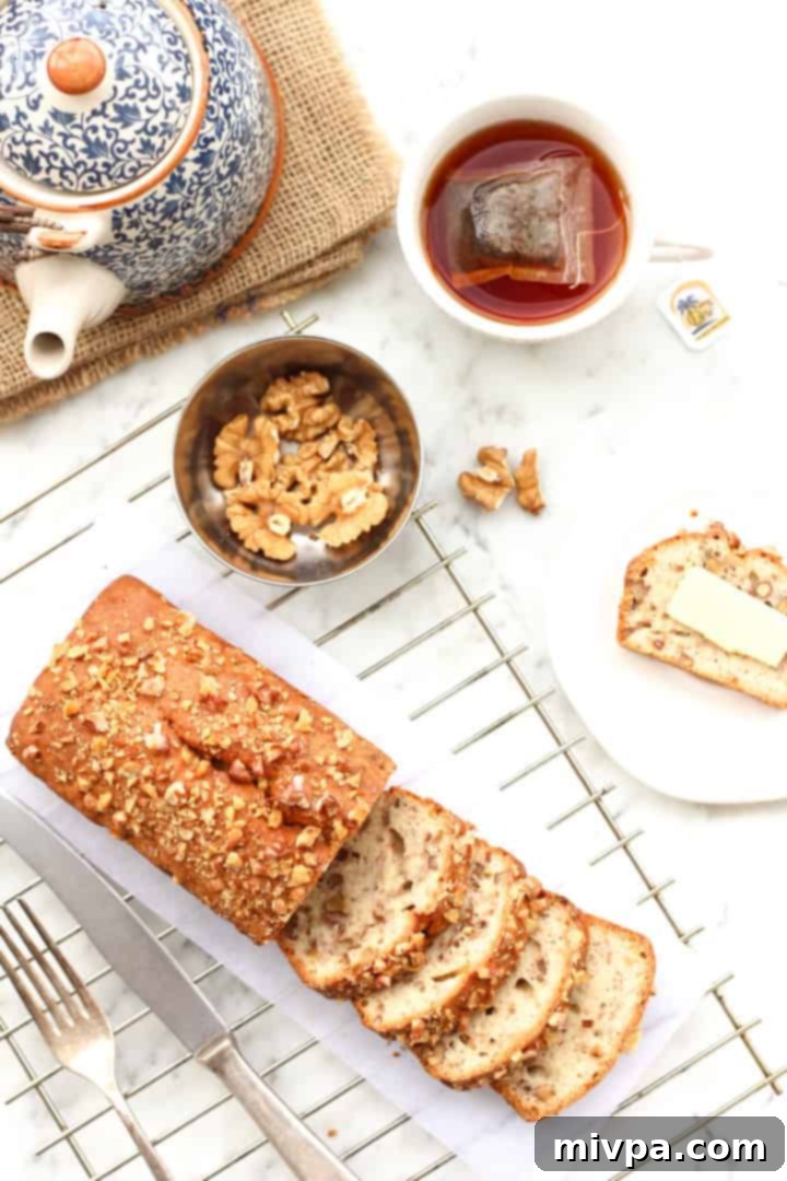 Gluten-free Banana Walnut Bread - Slices of moist banana bread on a wooden board, ready to be served.