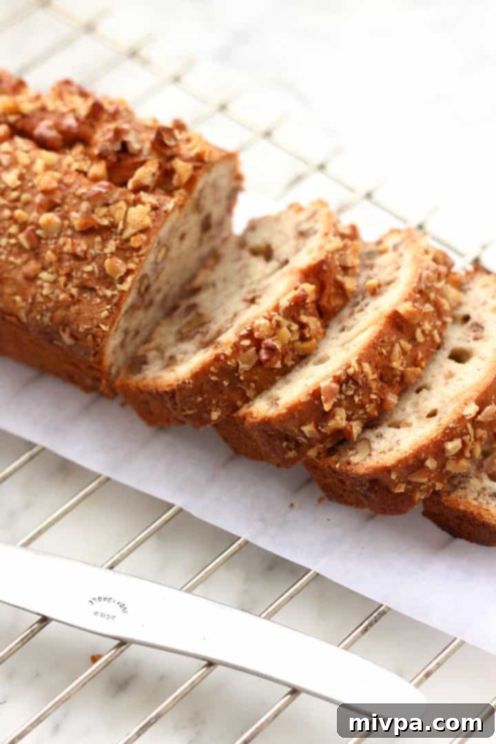 Gluten-free Banana Walnut Bread - Stack of banana bread slices on a small plate, ready to be eaten.