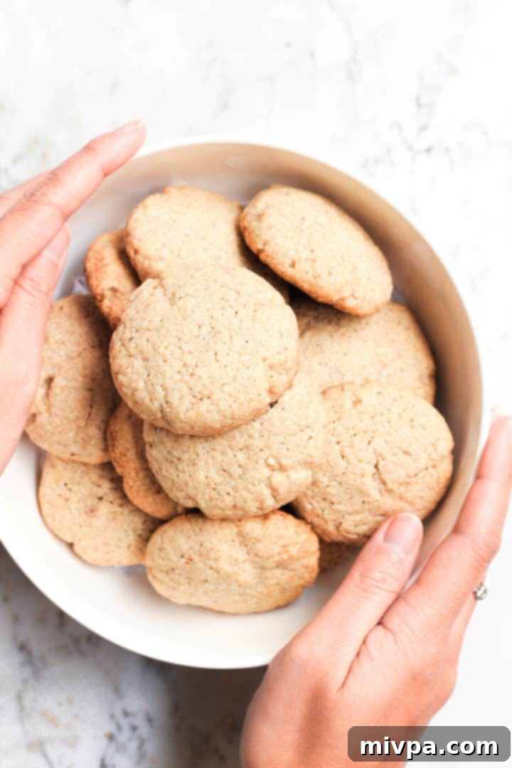 Easy Buckwheat Cookies (Gluten-Free, Dairy-Free) Hands holding a white bowl full of buckwheat cookies.