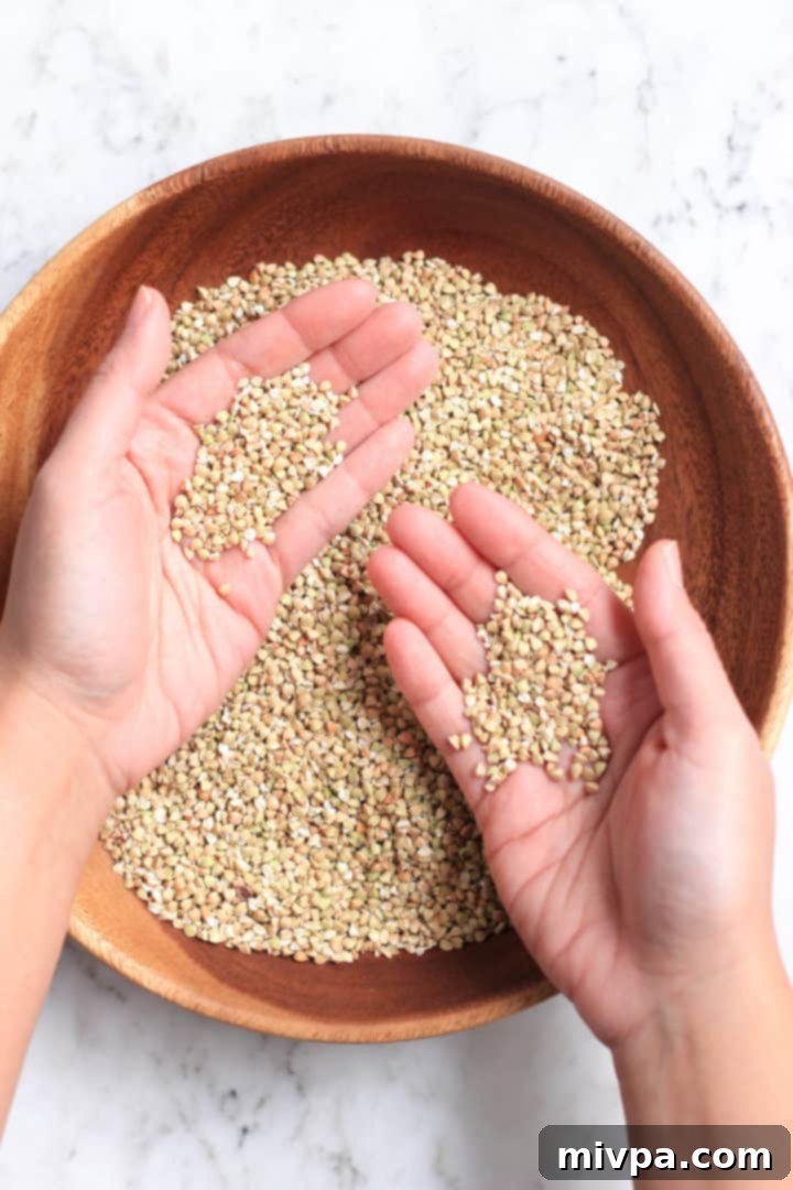 Easy Buckwheat Cookies (Gluten-Free, Dairy-Free) Hands holding buckwheat groats.