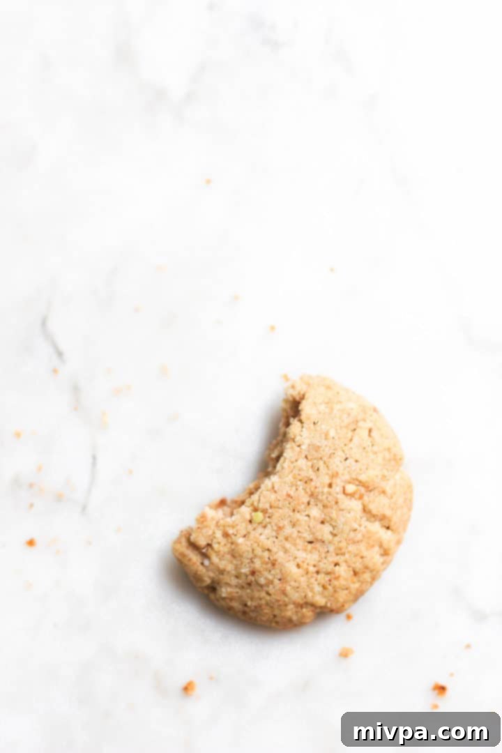 Easy Buckwheat Cookies (Gluten-Free, Dairy-Free) Half-eaten buckwheat cookie lying on a marble board.