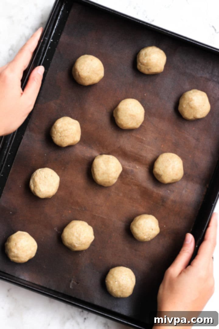 Easy Buckwheat Cookies (Gluten-Free, Dairy-Free) Round balls of buckwheat cookie dough spread out on a cookie sheet.