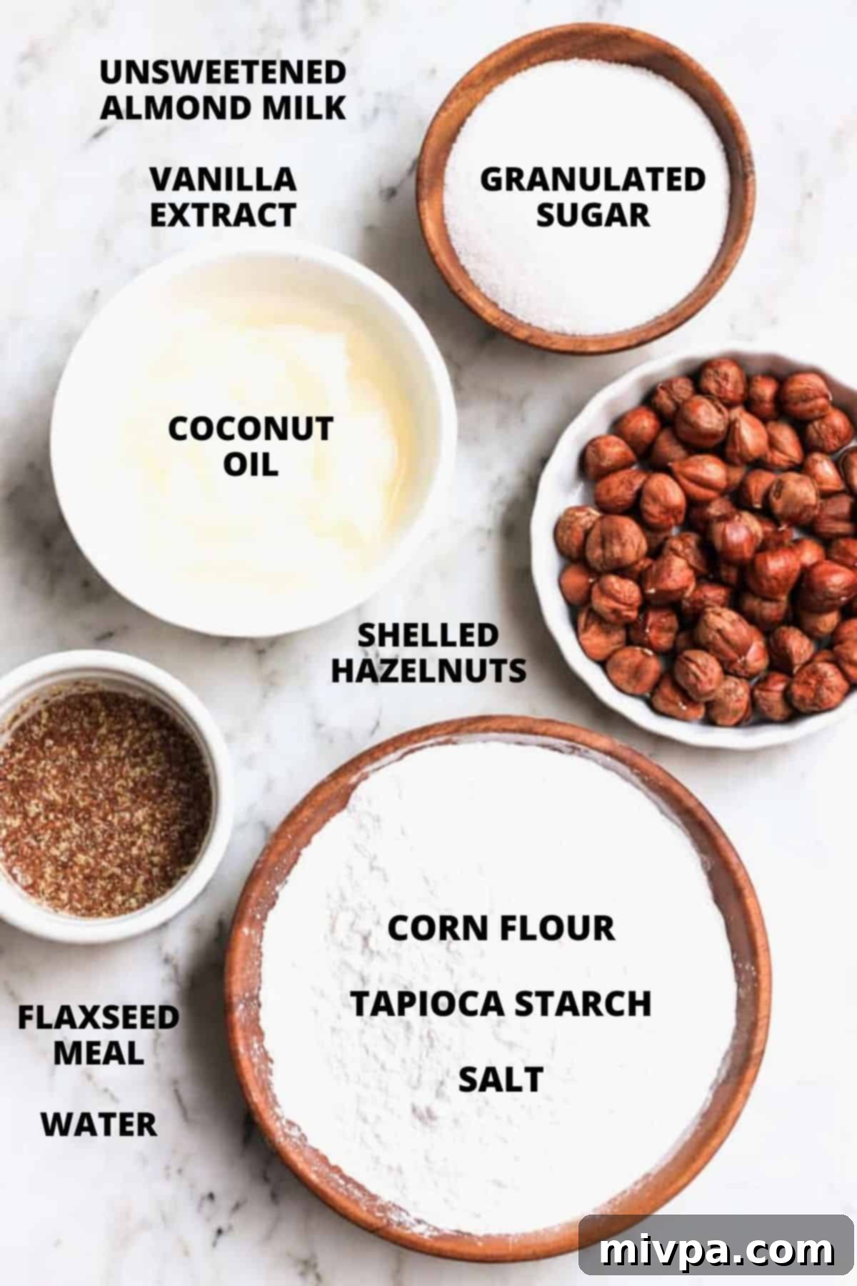 A flat lay photograph showcasing all the gluten-free hazelnut cookie ingredients.